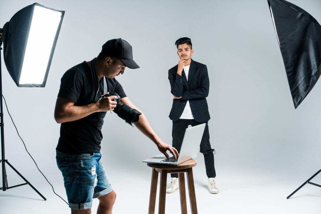 Professional photographer taking photos of indian model in studio with leight